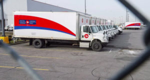Idle Canada Post trucks sit in the parking lot of the Saint-Laurent sorting facility in Montreal as rotating strikes hit the area on Nov. 15, 2018. Senators passed back-to-work legislation for postal workers on Monday. (Ryan Remiorz/The Canadian Press)